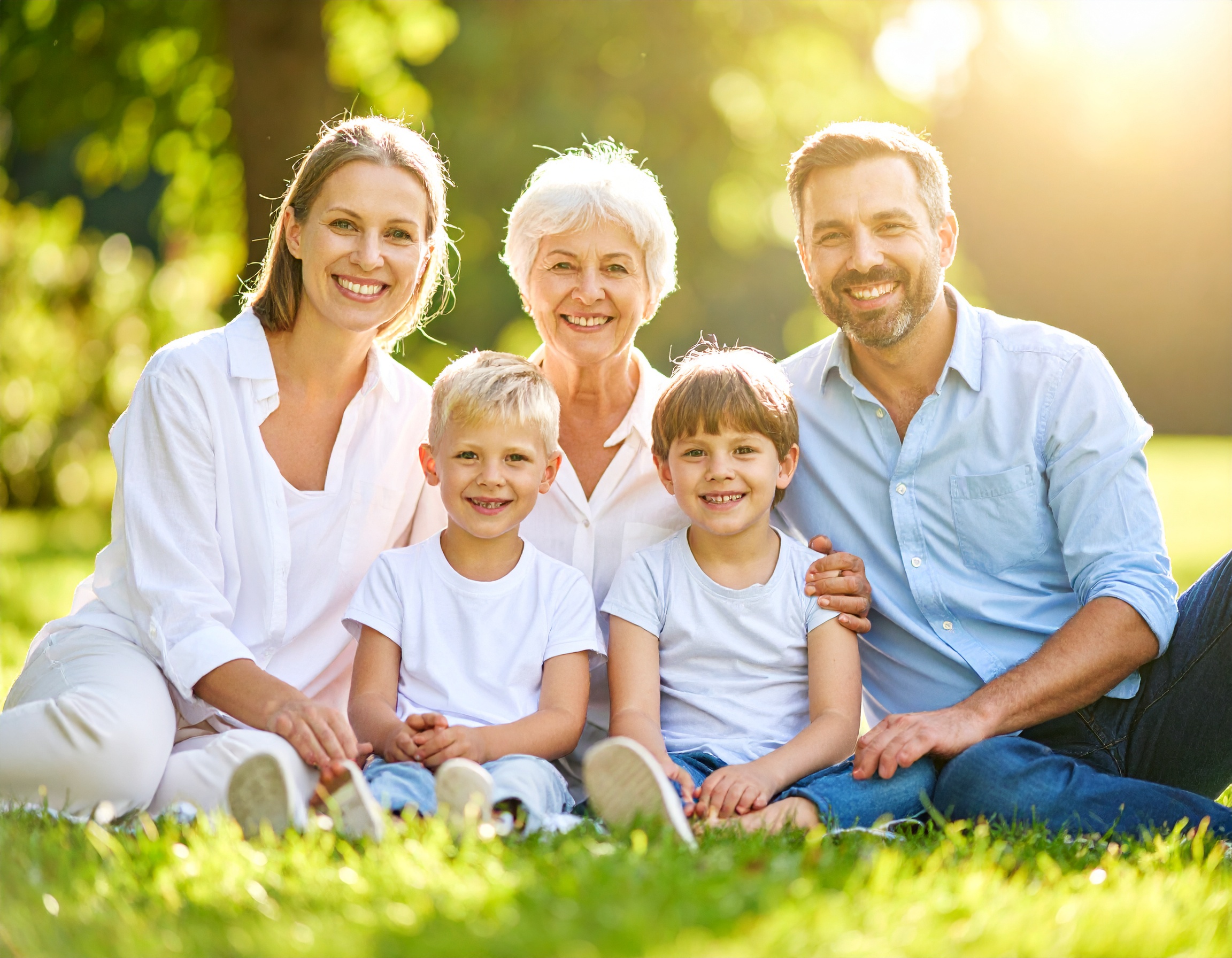 Firefly_Family with grand parent in the middle sitting on the grass bright sunny day real fac 557070
