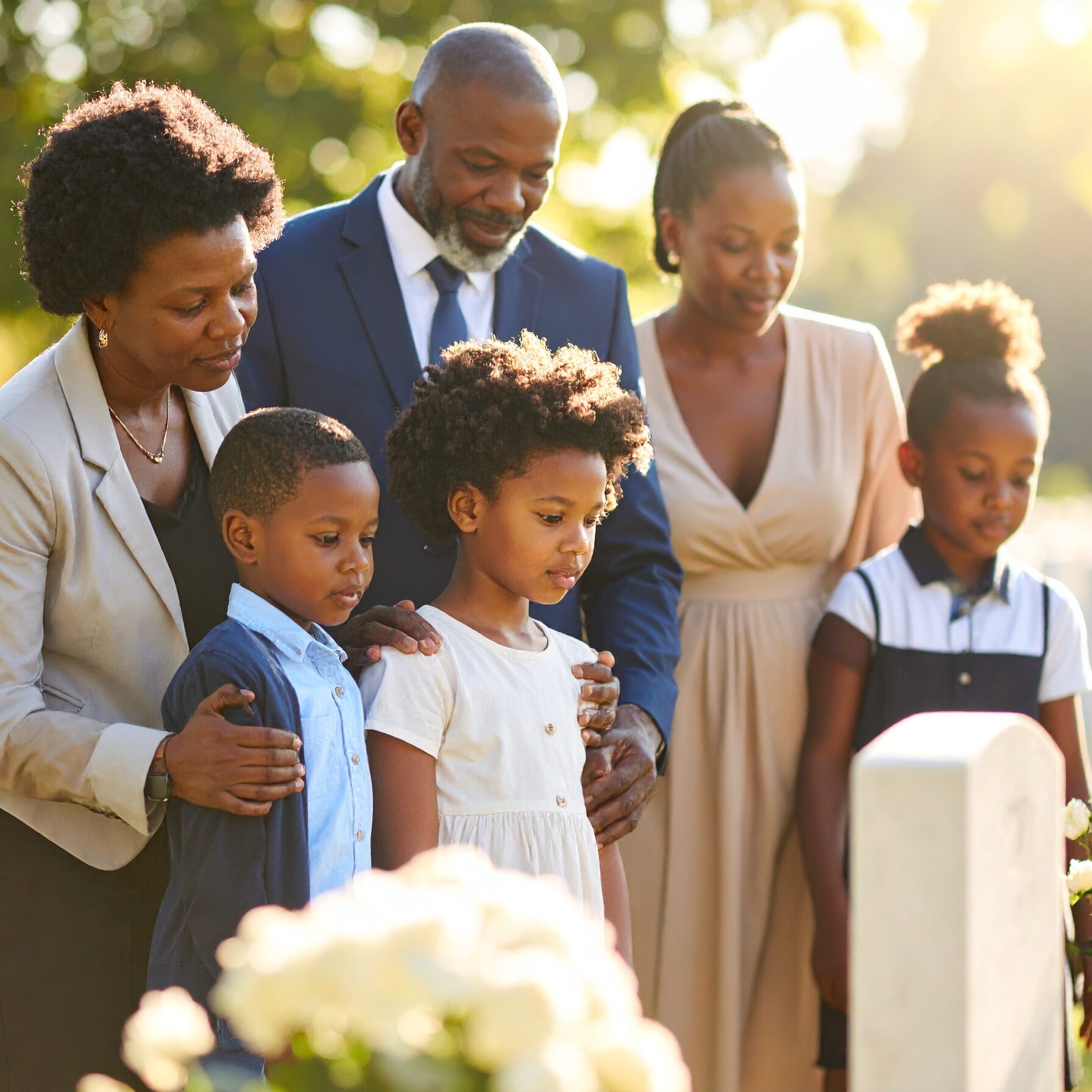 Firefly_parents keeping an eye on their children when at a cemetery attending a funeral cerem 380515